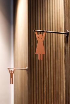 a paper cut out of a woman hangs on a clothes line in front of a door