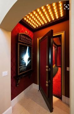 an open door leading to a hallway with a movie poster on the wall above it