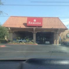 the ramada restaurant is located in an empty parking lot with cars parked outside it