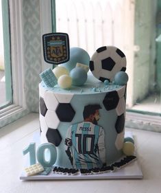 a soccer themed birthday cake is displayed in front of a window with the number ten on it