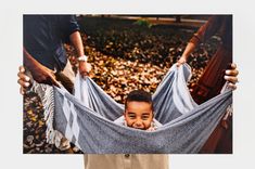 Woman holding a 20x30 Photo Print featuring a picture of a child being swung in a blanket over a bed of leaves. Get High, Cherished Memories, Long Lasting, Photo Lab, Online Printing, Photo Printing, In This Moment