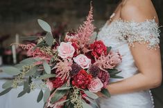 a woman holding a bouquet of flowers in her hands