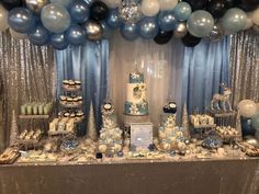 a table topped with lots of cake and balloons