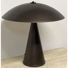 a large black lamp sitting on top of a wooden table