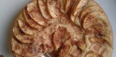 an apple pie on a white plate with a knife