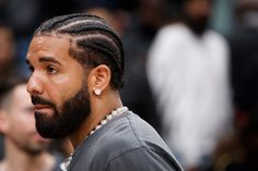 a close up of a man with dreadlocks on his head looking off to the side