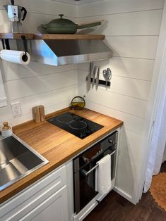 a stove top oven sitting inside of a kitchen next to a sink and countertop