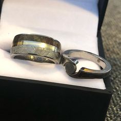 two wedding rings sitting on top of a box