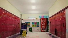 an empty hallway with lockers and coca - cola signs on the walls in front of them