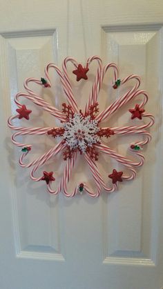 candy canes are arranged in the shape of a snowflake on a door