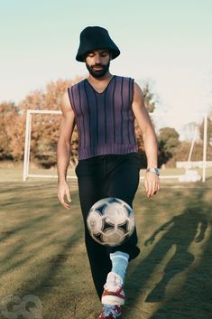 a man is kicking a soccer ball on the field