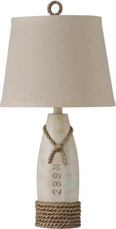 a table lamp with rope wrapped around the base and a white glass bottle on top