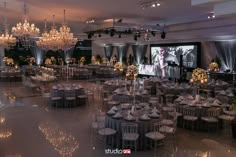 a large banquet hall with chandeliers and tables set up for a formal function