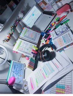 the desk is cluttered with school supplies and pens, books, and other items