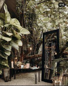 the interior of a restaurant with tables and plants on display in front of it, surrounded by greenery