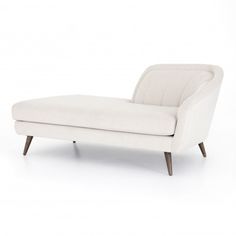 a white chaise lounge chair with wooden legs