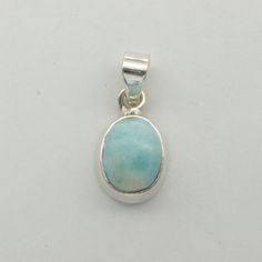 This is a beautiful Larimar Pendant in 925 Sterling Silver. The Larimar is from the Dominican Republic and is not treated in any way. There is also no nickel or other substances causing most allergies in the silver making the pendant hypo allergenic.  Size of the Pendant (incl. Bail) 3.0 x 1.4 cm 1.18 x 0.55 inch You will receive the item in a gift box - perfect to surprise someone or yourself. Usually we ship on the same day we receive the payment for the order. We want you to be happy with you Oval Blue Larimar Jewelry, Untreated Oval Silver Gemstones, Blue Oval Sterling Silver Gemstones, Larimar Pendant, The Dominican Republic, Waldorf Doll, Fine Jewellery Necklace, To Be Happy, Dominican Republic