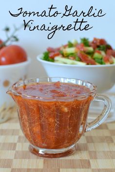 tomato sauce in a glass gravy dish next to a bowl of salad