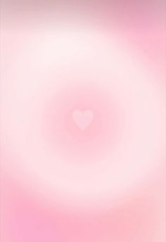 a blurry pink background with a heart in the center