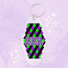 a keychain with the words desert galaxy designs on it and stars in the background