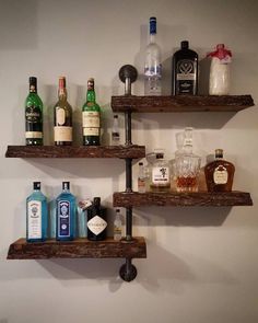 three wooden shelves with bottles on them