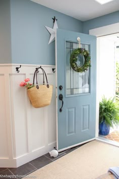 a blue front door with a basket hanging on it's side and a star decoration above the door