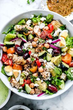 a white bowl filled with salad and dressing