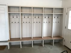 an empty room with several benches and lockers