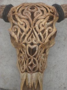 an animal's skull with intricate carvings on it