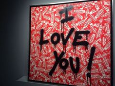 a painting with the words i love you written in black and red spray paint on it