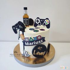 a birthday cake decorated with video game related items and a bottle of liquor on top