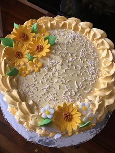 there is a cake with yellow flowers on it