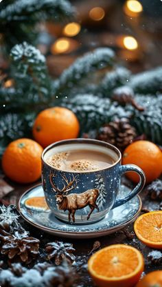 a cup of coffee sitting on top of a saucer surrounded by oranges and pine cones