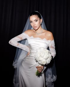 a woman in a wedding dress holding a bouquet