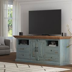 an entertainment center in a living room with a flat screen tv