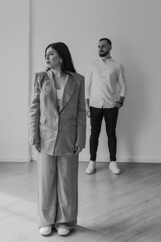 black and white photograph of two people standing next to each other in an empty room