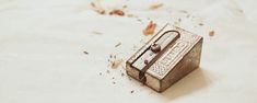 a small metal box sitting on top of a white sheet covered in dirt and debris