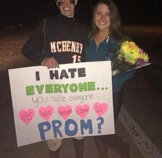 two people holding a sign that says i hate everyone, you hate everyone prom?