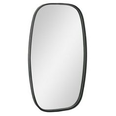 a mirror that is on the wall with a black frame and an oval shaped edge