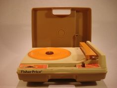 an old fashioned record player in a plastic case