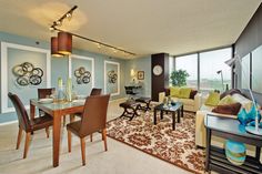 a living room filled with furniture and a large window