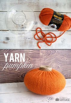 an orange yarn pumpkin sitting on top of a wooden table next to a ball of yarn