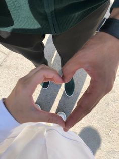 two people making a heart with their hands