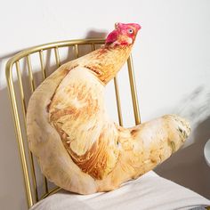 a chicken statue sitting on top of a chair