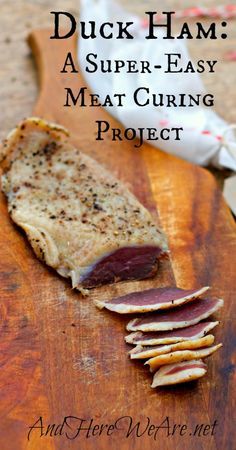 a piece of meat sitting on top of a wooden cutting board