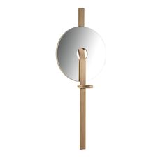 a round mirror with a wooden stick in front of it