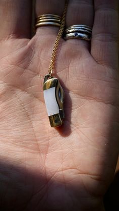 A beautiful folding knife necklace, crafted with stainless steel and brass and natural white shell abalone. These necklaces are unisex and the perfect gift. Coming hung on either a 14k gold filled chain or sterling silver of your desired chain length, please select from the drop down menu. Wear at your own risk, these knives are sharp - Make sure knife is folded close when wearing on neck to avoid injury. - Knife measures 6 cm long (when open) - Brass + Stainless Steel Knife with with Sterling S White Jewelry With Lobster Clasp For Everyday Use, Pocket Knife Necklace, Knife Necklace, Jewelry Essentials, Folding Knife, Abalone Shell, Gold Filled Chain, Chain Lengths, Pocket Knife