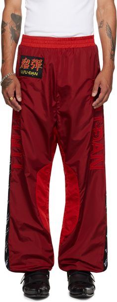 Relaxed-fit nylon taffeta track pants. · Elasticized waistband and cuffs · Two-pocket styling · Logo patch at front · Logo appliqués at front legs · Graphic trim at outseams · Full mesh lining Supplier color: Oxblood/Red Mockup Idea, Men Drip, Cool Kidz, Man Dressing Style, Brand Ideas, Oxblood Red, Concept Clothing, Mens Dress, Mens Joggers