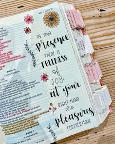 an open bible with the words in your presence there is always at you and flowers on it