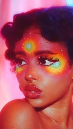 an image of a woman with bright makeup and eyeliners on her face, looking at the camera